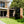 Load image into Gallery viewer, Modern house exterior with a black cube-like structure in the garden