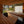 Load image into Gallery viewer, Modern outdoor patio with wooden furniture and a view of a garden.