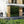Load image into Gallery viewer, Modern house exterior with a glass wall and wooden panels