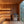 Wooden sauna interior with benches and a window view of trees