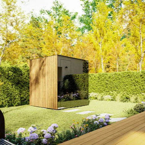 Wooden shed in a garden with trees and flowers