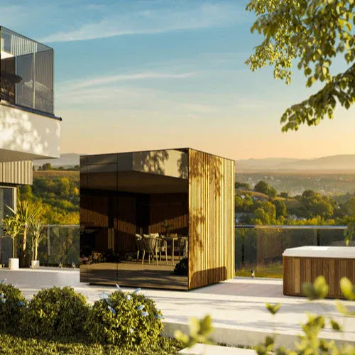 Modern house with a reflective gold exterior in a scenic landscape.