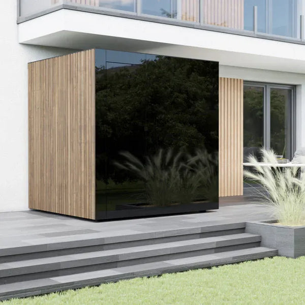 Modern house exterior with a large reflective surface and wooden paneling.